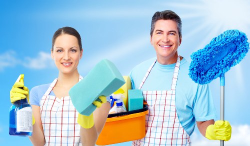 Cleaner following safe work practices while preparing a room